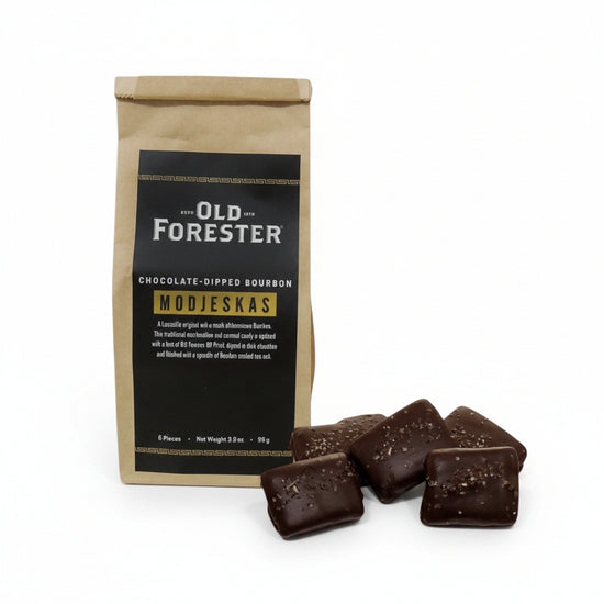 Old Forester chocolate-dipped bourbon Modjeskas with packaging on a white background