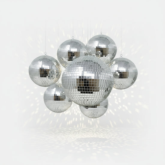A handcrafted disco ball by Omega Mirror hanging from the ceiling, casting sparkling light around a room.