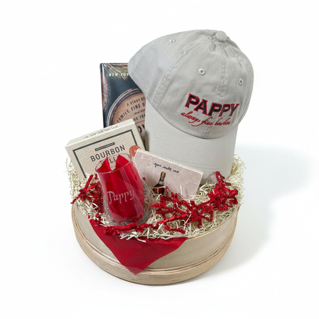 Gift basket with Pappy Van Winkle's cap, bottle, and cards on a white background