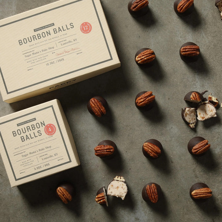 Bourbon balls with packaging on a gray surface