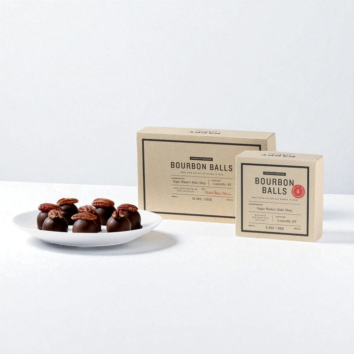 Bourbon Balls on a plate with two boxes labeled 'Bourbon Balls' on a white background