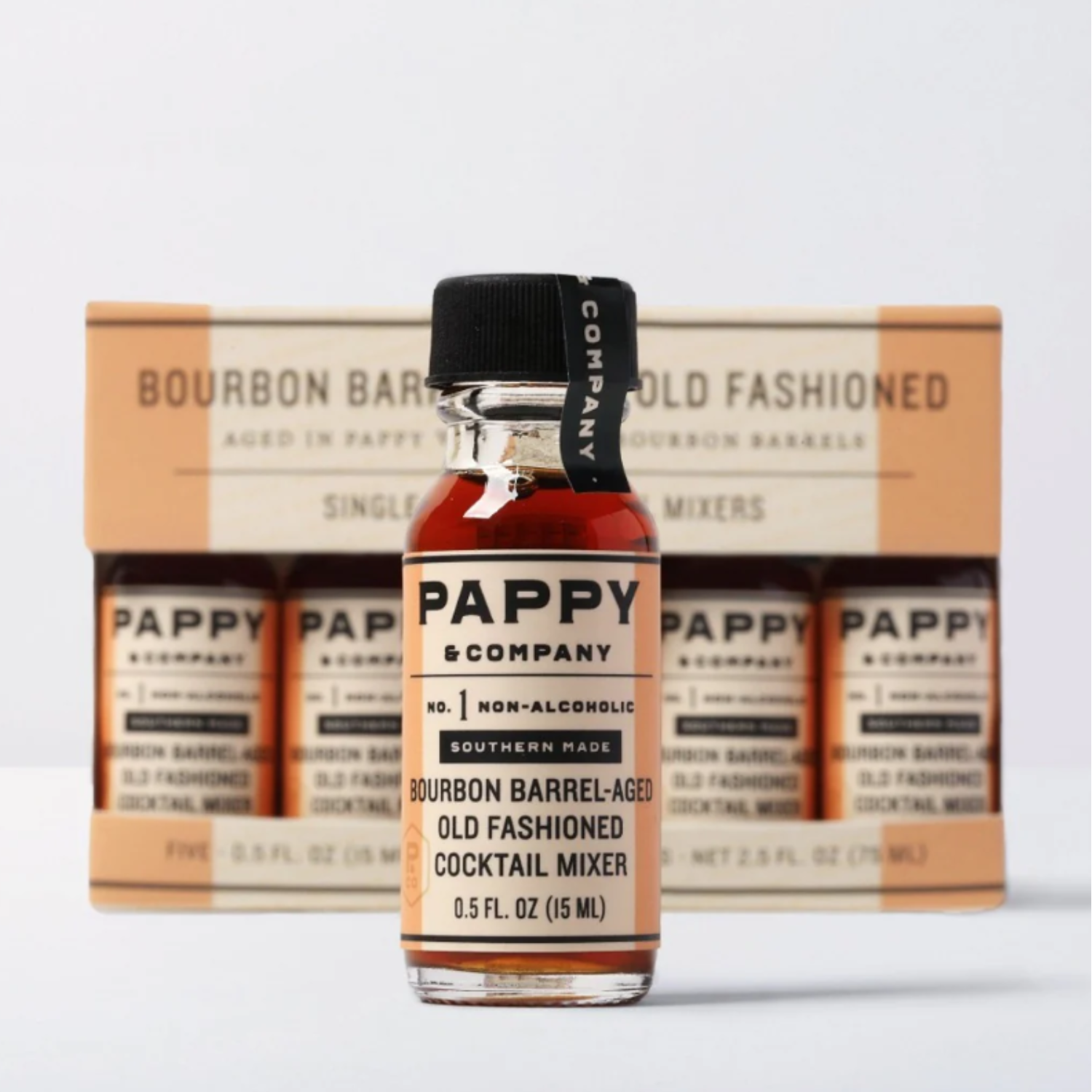 Bottle of Pappy & Company non-alcoholic cocktail mixer with packaging in the background.