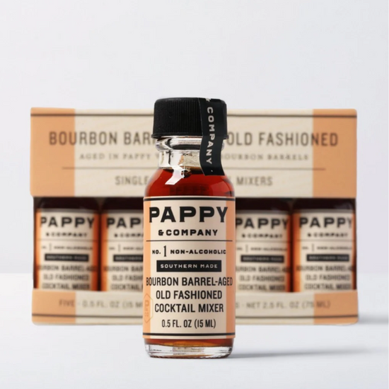 Bottle of Pappy & Company non-alcoholic cocktail mixer with packaging in the background.