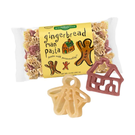 Packaged gingerbread man pasta with a house-shaped piece on a white background
