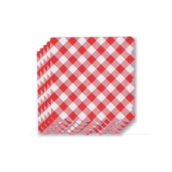 A staggered, diagonal stack of red-and-white gingham cocktail napkins fanned out against a clean white background, highlighting their decorative scalloped edges.