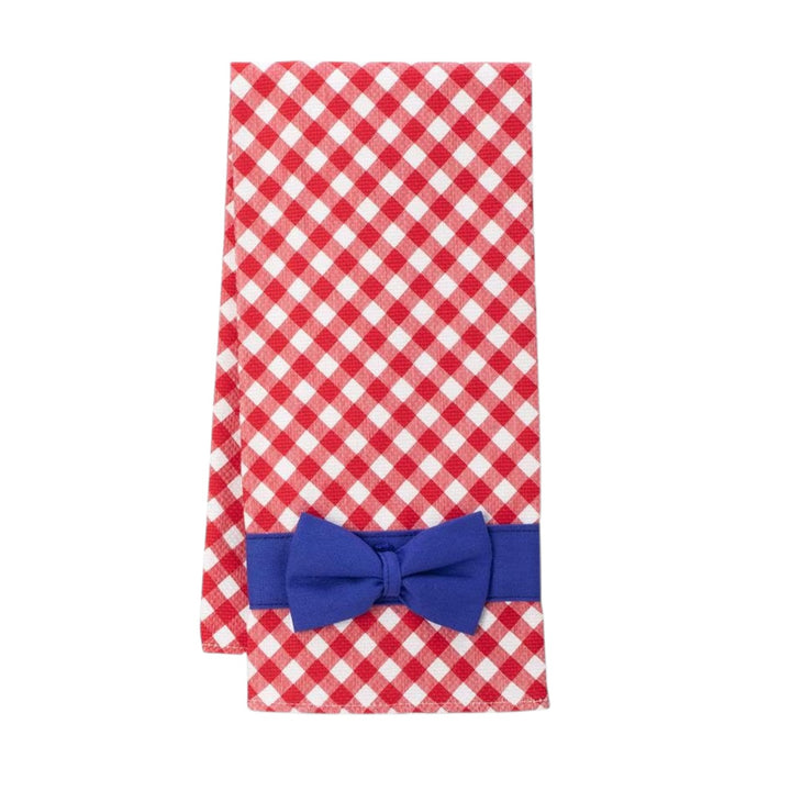 Flat lay of a red-and-white gingham checkered tea towel featuring a royal blue band and decorative bow.