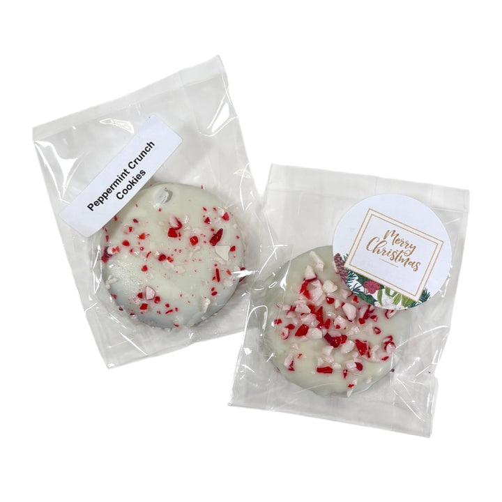 A collection of Peppermint Crunch Cookies coated in white chocolate and red and white sprinkles.