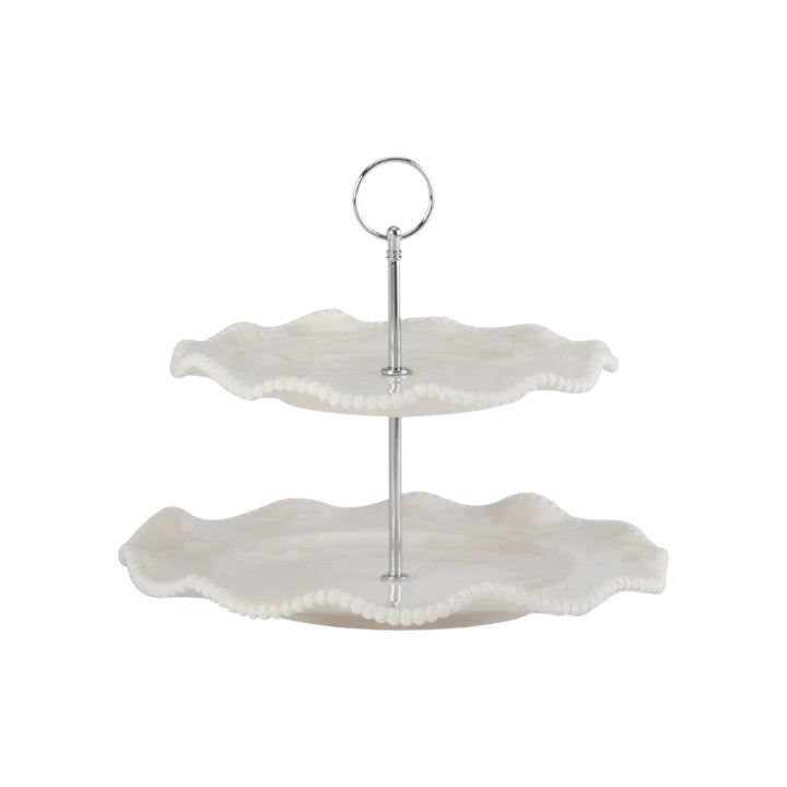 Two-tiered white ceramic cake stand with scalloped edges on a white background