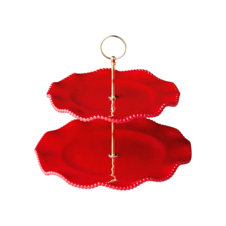 Two-tiered red cake stand with gold accents on a white background