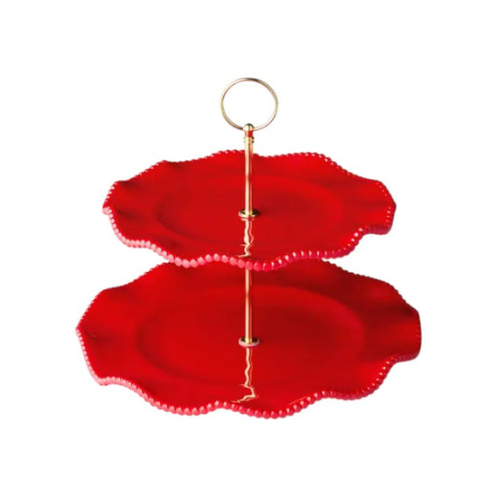 Two-tiered red cake stand with gold accents on a white background