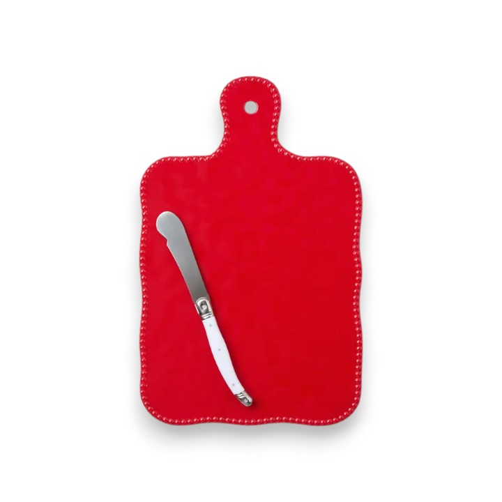 Red cutting board with a silver knife on a white background