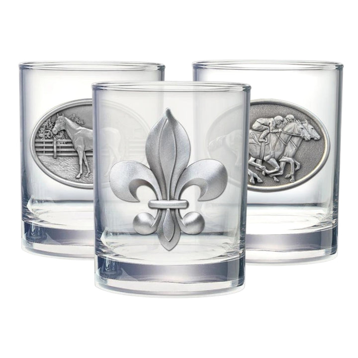 Three clear glasses with silver fleur-de-lis designs on a white background