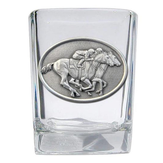 Clear glass shot glass with a silver horse and jockey emblem on a white background