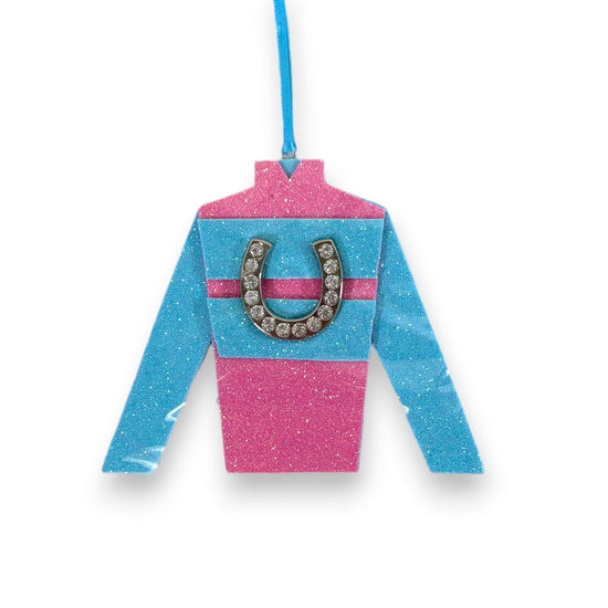 Decorative jockey shirt ornament with pink and blue design and horseshoe on a white background