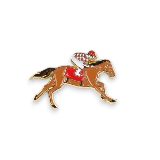 A detailed enamel pin of a jockey in red and white checkered silks riding a galloping brown racehorse.