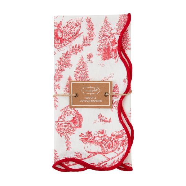 A set of four red and white Christmas toile dinner napkins, neatly folded and tied.