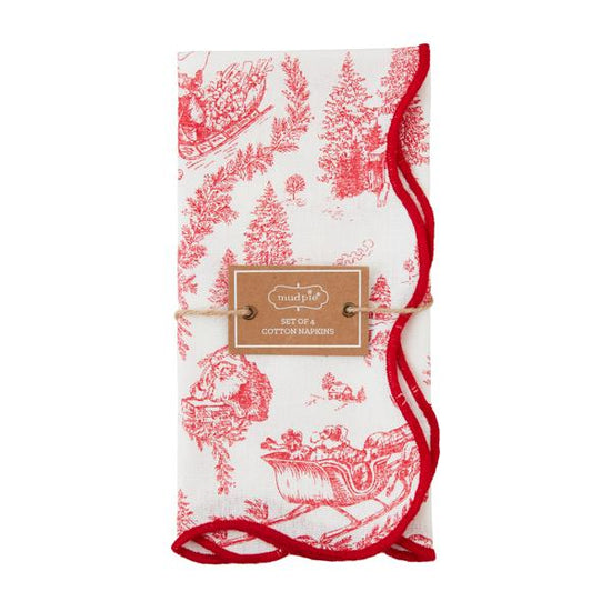 A set of four red and white Christmas toile dinner napkins, neatly folded and tied.