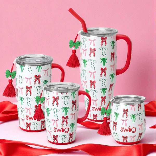 Lifestyle image showing the full Swig Ribbons and Bows drinkware collection on a pink background.