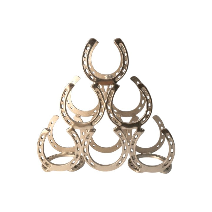 A front-facing view of the gold aluminum wine rack, showing the textured horseshoe details and 6-bottle capacity.