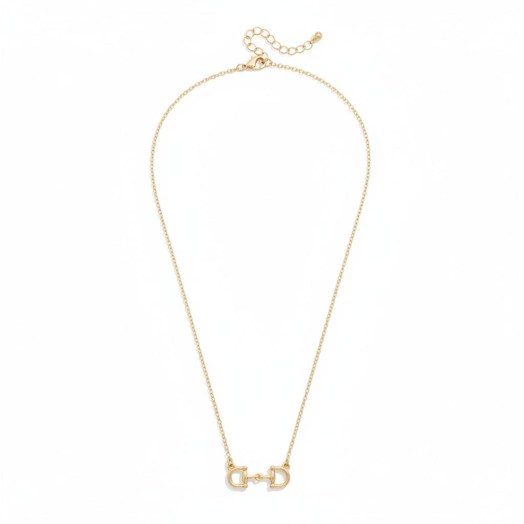 The Roux Horsebit Necklace in shiny gold, displayed on a white background to showcase the delicate chain and central D-ring snaffle bit pendant.