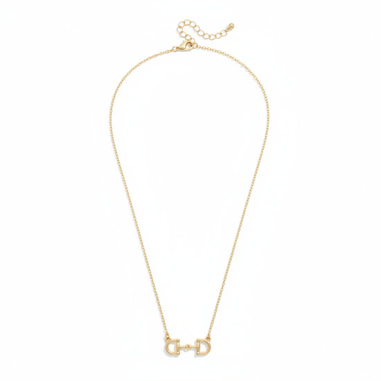 The Roux Horsebit Necklace in shiny gold, displayed on a white background to showcase the delicate chain and central D-ring snaffle bit pendant.
