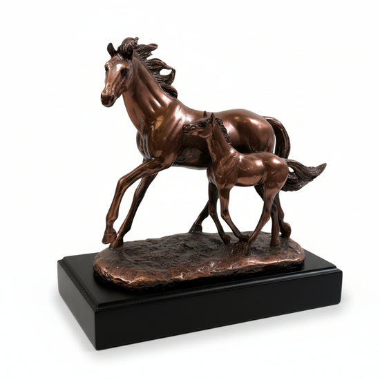 The dynamic copper Mom & Foal sculpture, showing the horses in a full run, displayed on a console table.