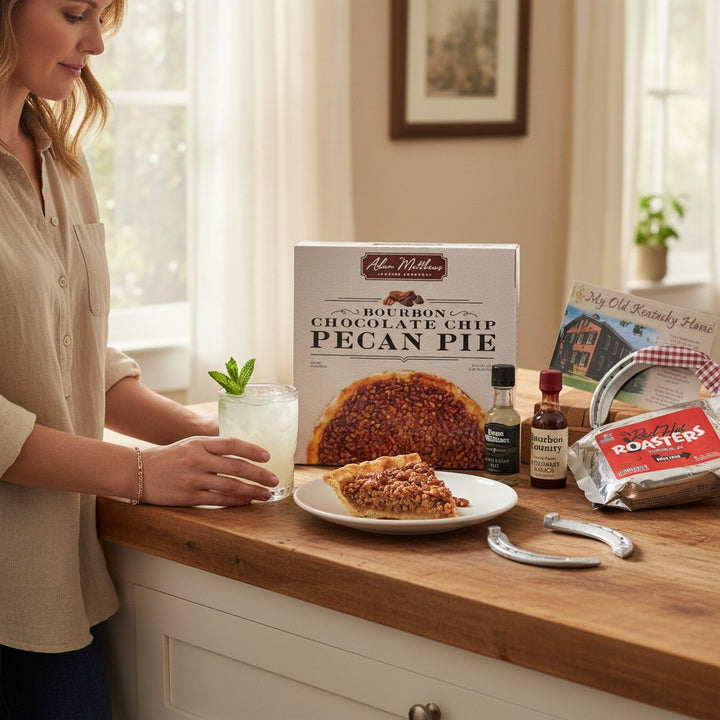 A warm lifestyle shot of a slice of Bourbon Chocolate Chip Pecan Pie being served with coffee.