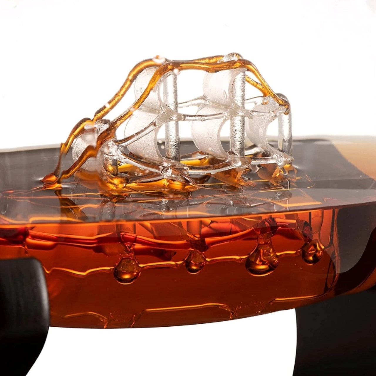 A close-up of the handblown ship inside the 1000ml barrel-shaped whiskey decanter.
