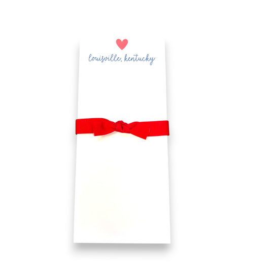 Notepad with a red bow and 'Louisville, Kentucky' text on a white background
