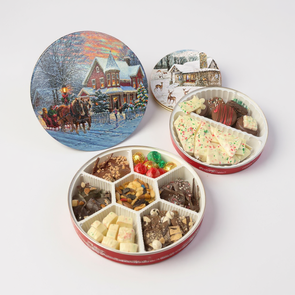 A side-by-side photo of the small and large Christmas tins with their festive lids.