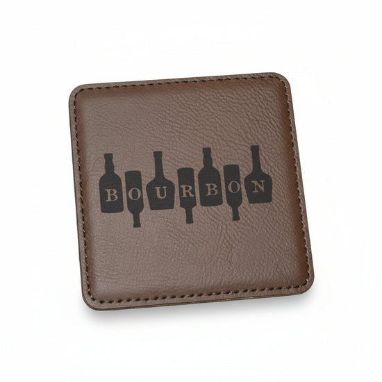 Close-up of the square brown genuine leather coaster showing the word "BOURBON" spelled out inside bottle silhouettes.