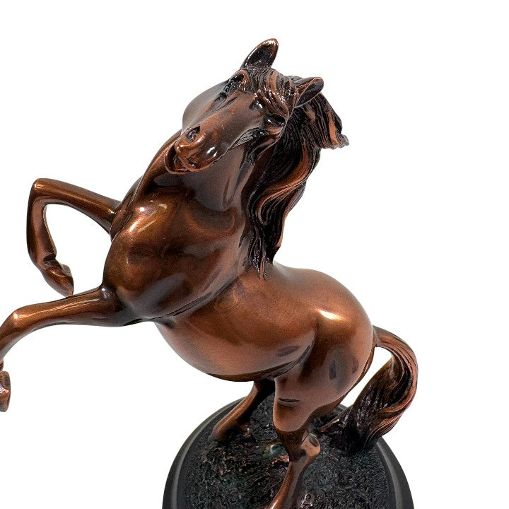 Close-up detail of the muscle definition and copper finish on the rearing stallion figurine.