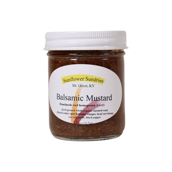 Jar of balsamic mustard with a white label on a white background
