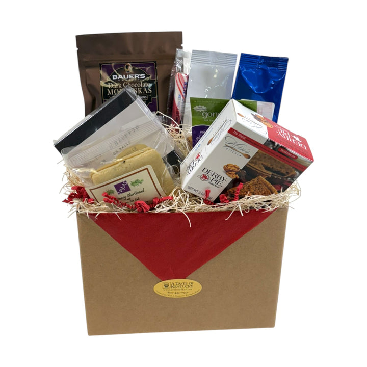 The Sweet Sampler Gift Box displayed in a kraft box, filled with gourmet sweets like a Derby Tart, bourbon balls, and shortbread.