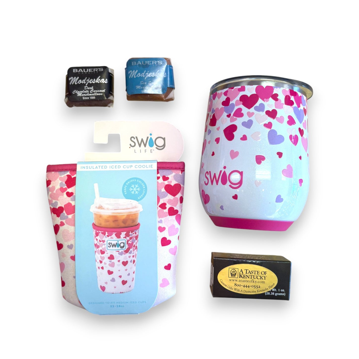 Top-down view of the gift basket contents: Swig Stemless Wine Cup, Swig Coolie, bourbon balls, and Modjeskas.