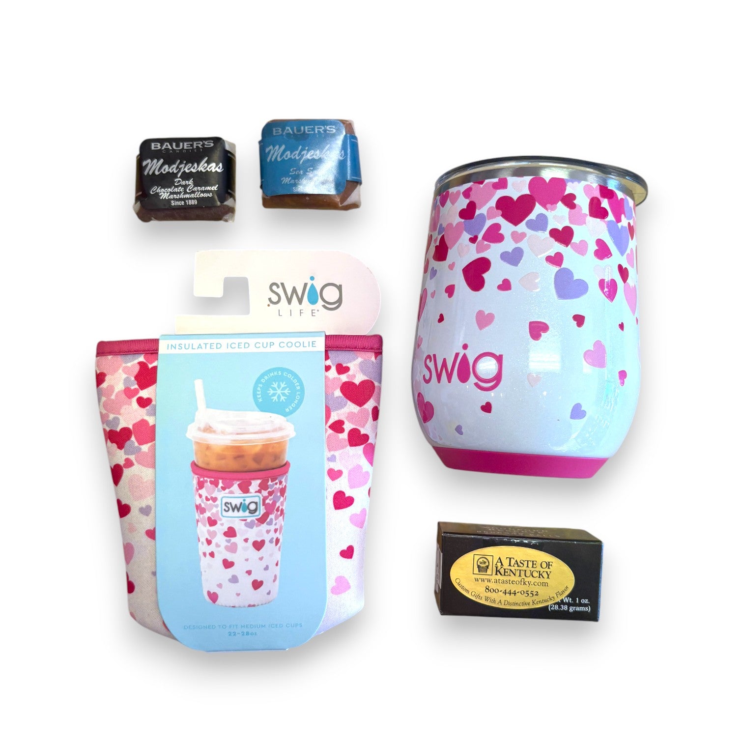 Top-down view of the gift basket contents: Swig Stemless Wine Cup, Swig Coolie, bourbon balls, and Modjeskas.