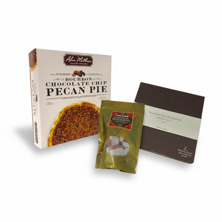 The Sweet Trio gift set featuring a Bourbon Chocolate Chip Pecan Pie, a box of Woodford Reserve Bourbon Balls, and Bauer's Modjeskas.