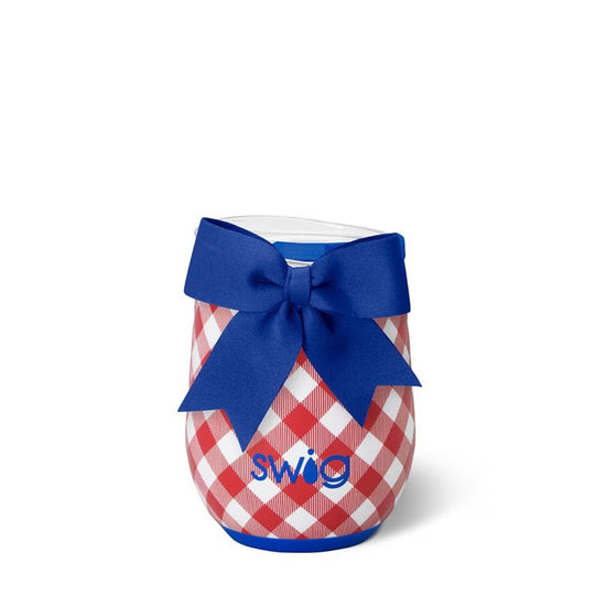 The 12oz Swig Life stemless wine cup showing a red and white checkered design, a solid blue silicone base, and a matching decorative bow.