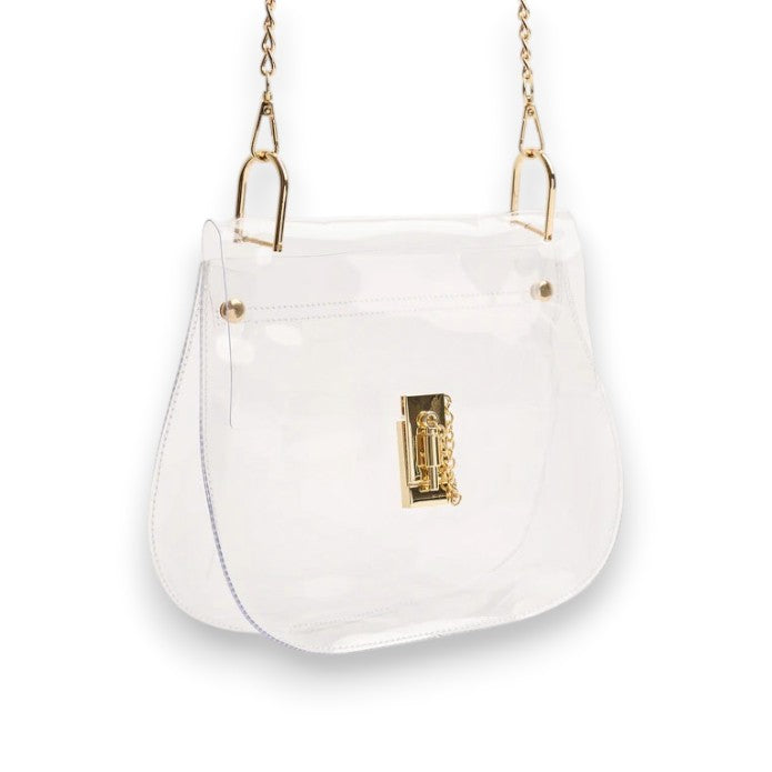 A clear plastic crossbody bag with a curved saddle shape and an elegant gold turn-lock closure on a white surface.