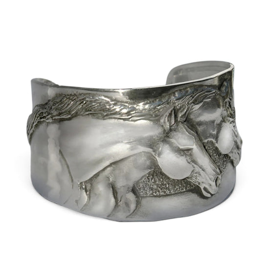 Second studio product photo of the Two Horse Heads Pewter Cuff Bracelet on a white background, highlighting the polished mirror finish and textured horse mane details.