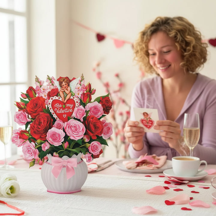 A person holding the Cupid's Valentine pop-up card, showing its impressive size and vibrant colors.