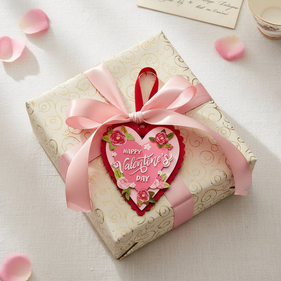 Gift box with pink ribbon and heart-shaped Valentine's Day card tag on a light background