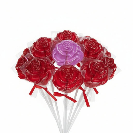 Red rose-shaped lollipops on sticks with one pink lollipop in the center against a white background