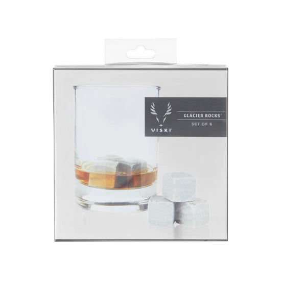 Packaged set of Viski Glacier Rocks with a glass of whiskey and ice cubes on a white background.