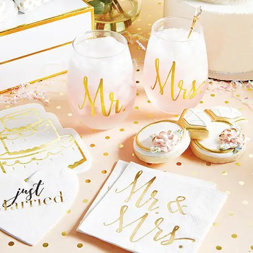 A festive wedding reception table featuring the Mr. and Mrs. toasting glasses.