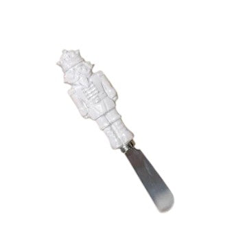 The all-white ceramic royal nutcracker cheese spreader shown individually.