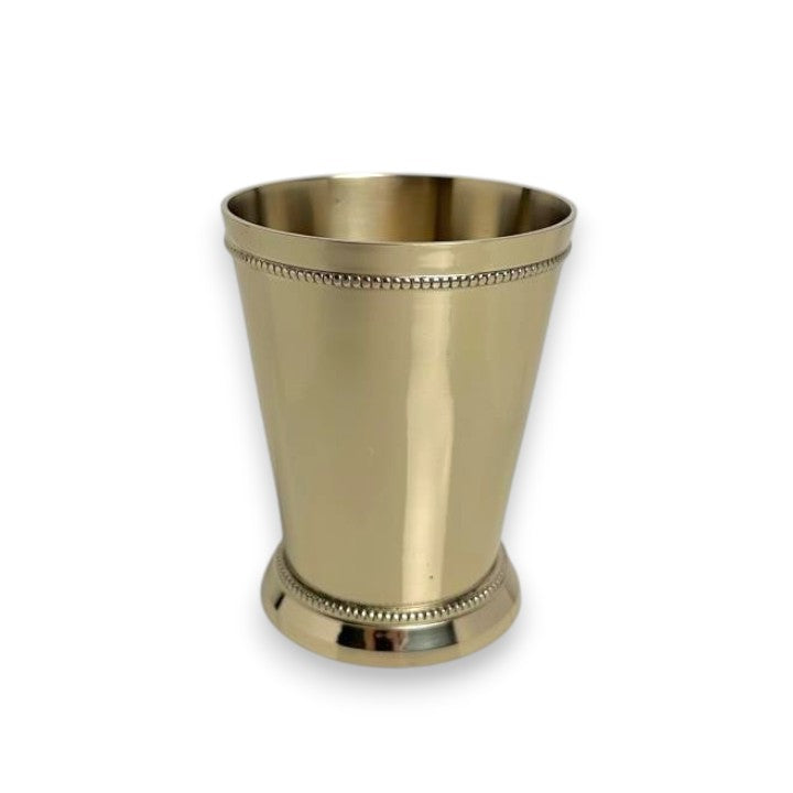 A studio shot of the polished brass mint julep cup against a white background, highlighting the luxurious gold finish and decorative beaded trim on the rim and base.