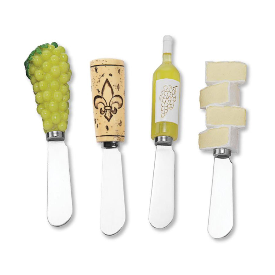 Set of four cheese knives with decorative handles on a white background