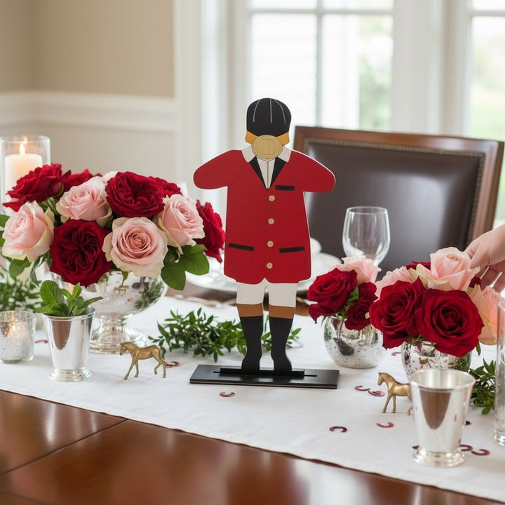  The wooden Derby bugler used as a festive centerpiece on a party table surrounded by roses and other decor.