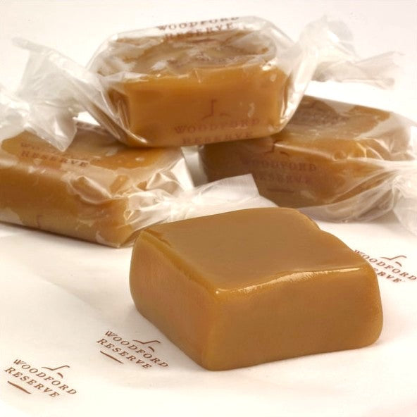 Woodford Reserve bourbon caramels in clear packaging on a white surface